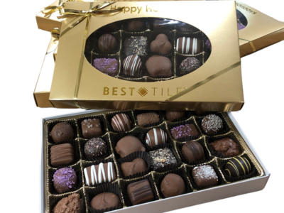 beautiful god box filled with chocolates with a company logo