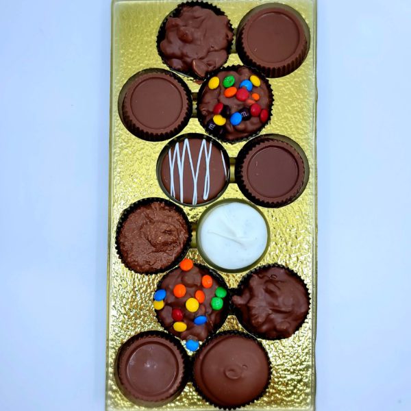 a gold box with twelve individual chocolate treats