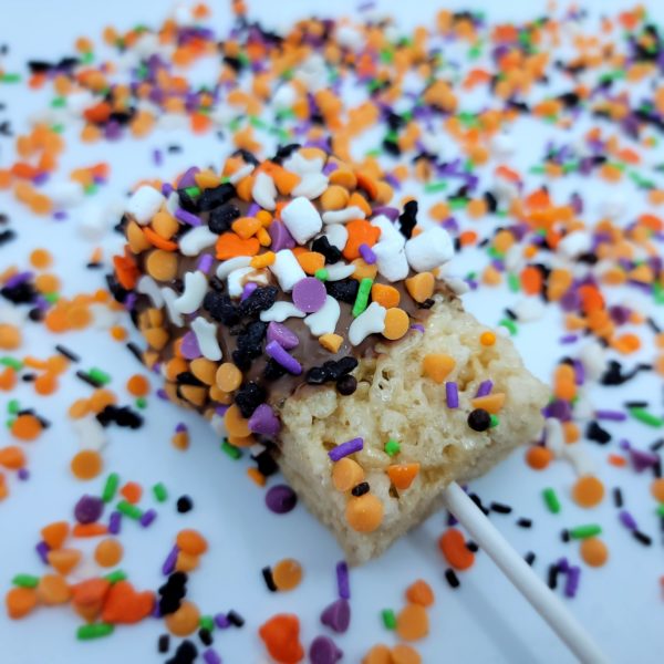 rice Krispy treat pop dipped in chocolate and sprinkled with Halloween candies