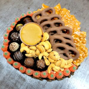 Charcuterie Board with Truffles, pumpkin pie fudge pretzels peanut brittle and jelly pumpkins